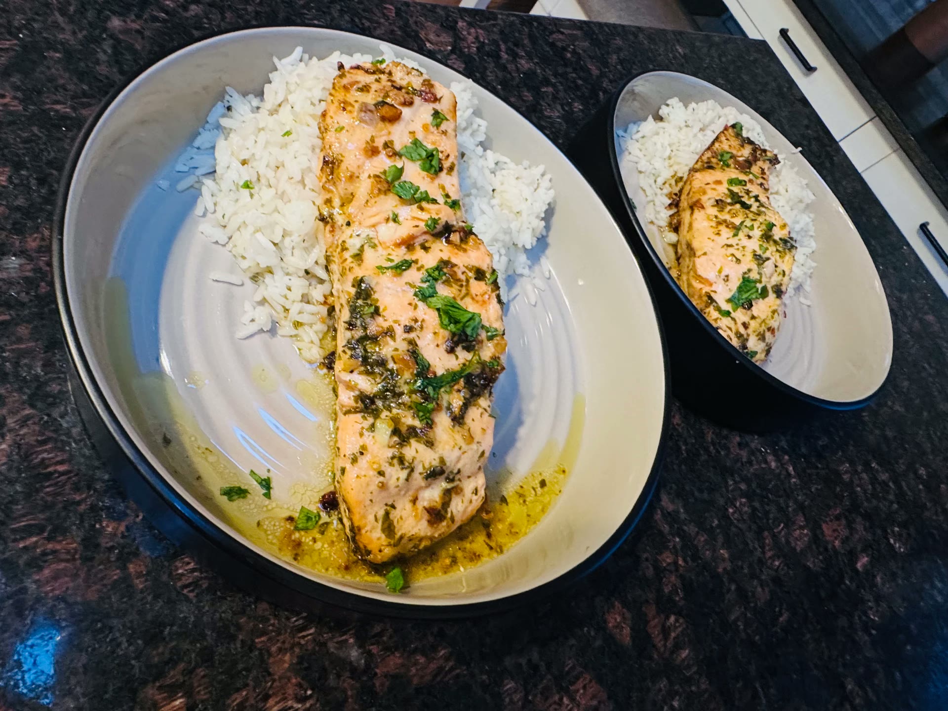 Citrus salmon fillet with herbs, served over herb rice in a ceramic dish